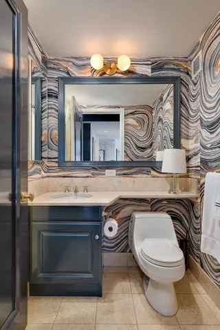 a bathroom with a toilet a sink and a mirror