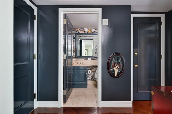 a view of a hallway with entryway wooden floor and a livingroom view