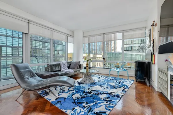 a living room with furniture and a floor to ceiling window