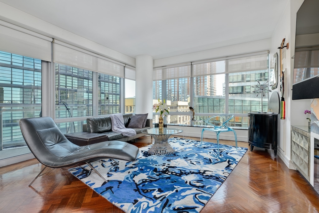 1 Avery Street, Unit 10D Boston, MA 02111 - Photo 2 of 21 a living room with furniture and a floor to ceiling window