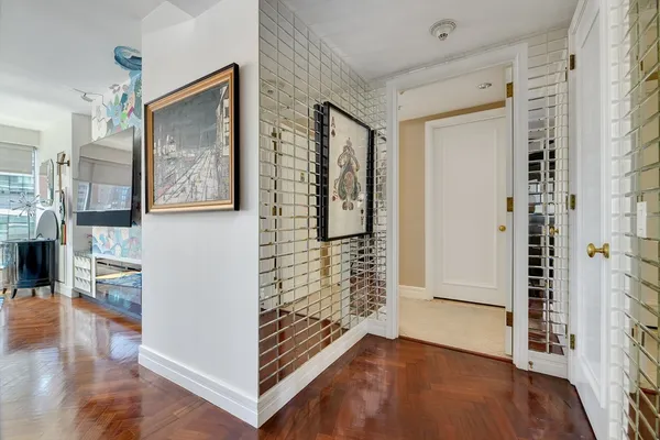 a view of a hallway with wooden floor and staircase