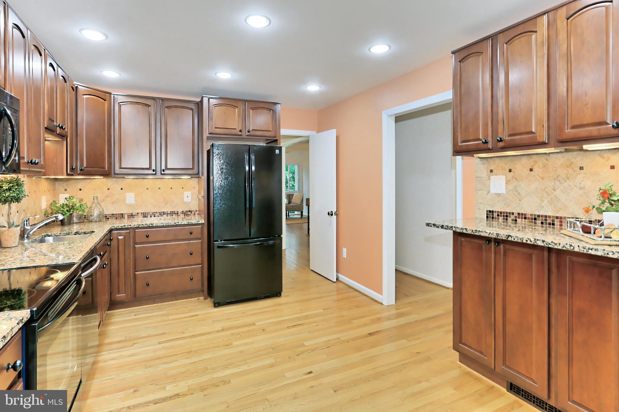 11704 Newbridge Court Reston, VA 20191 - Photo 6 of 64 Recessed lights & warm hardwoods frame the kitchen