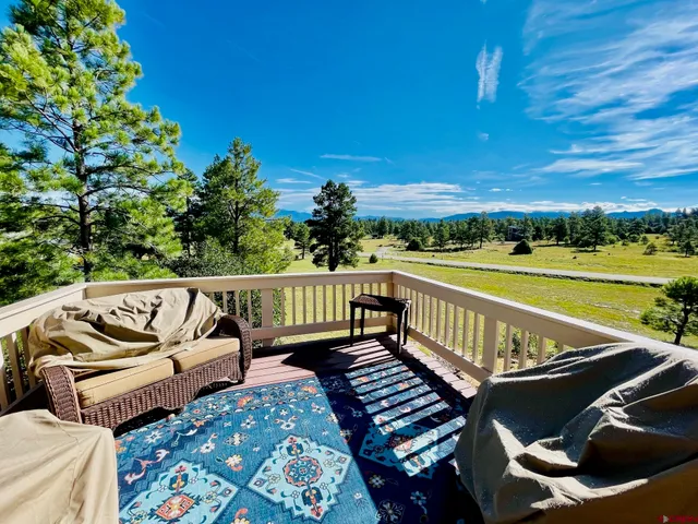 a view of a roof deck with couches and wooden floor