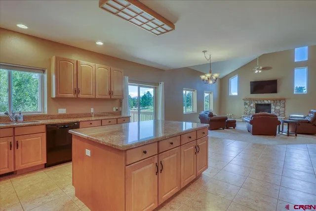 a kitchen with sink refrigerator and large window