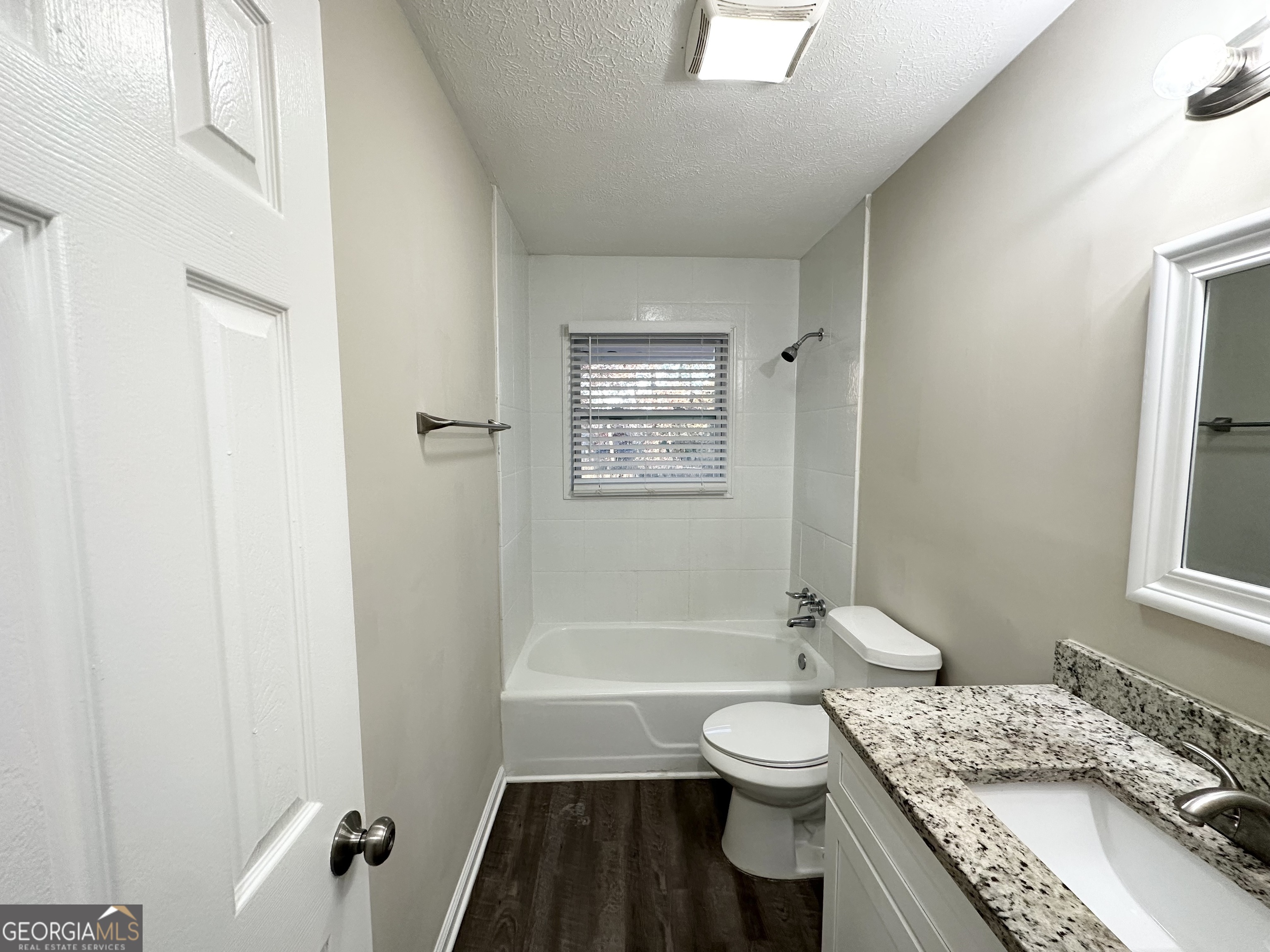 2852 Port Royal Lane Decatur, GA 30034 - Photo 13 of 18 a bathroom with a granite countertop toilet a sink and a bathtub