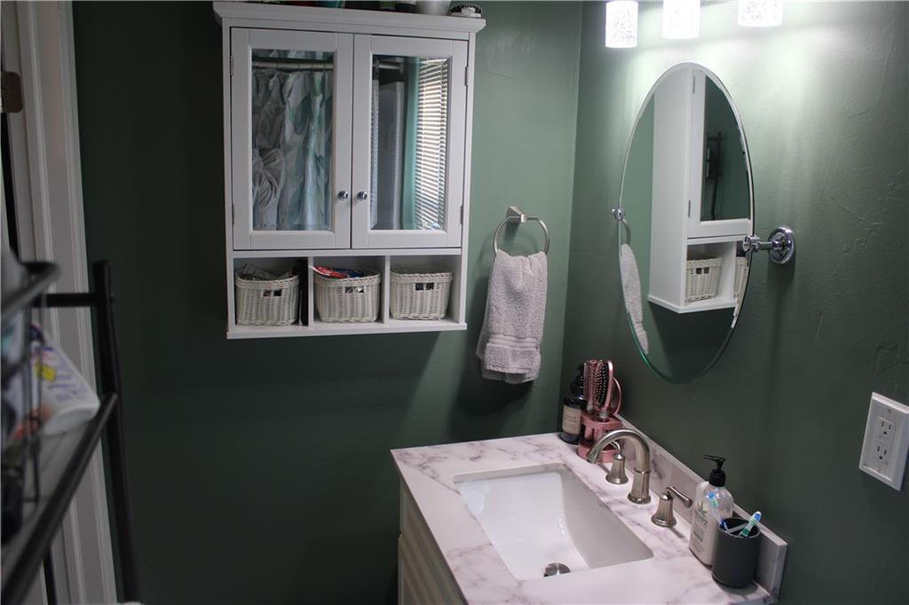 121 Powell Road Butler, PA 16002 - Photo 17 of 49 a bathroom with a sink and mirror