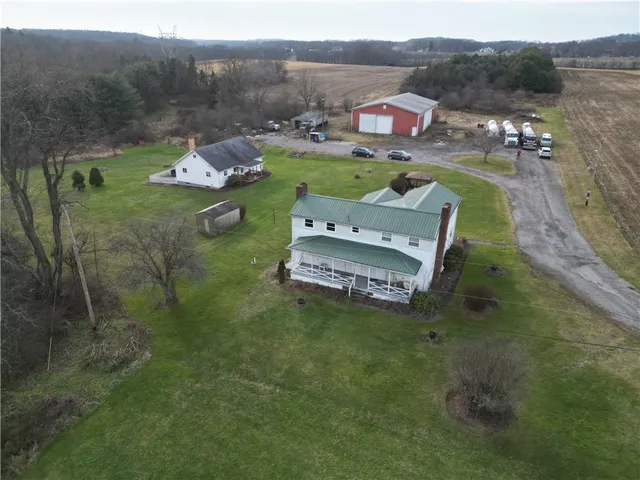 an aerial view of a house with a yard