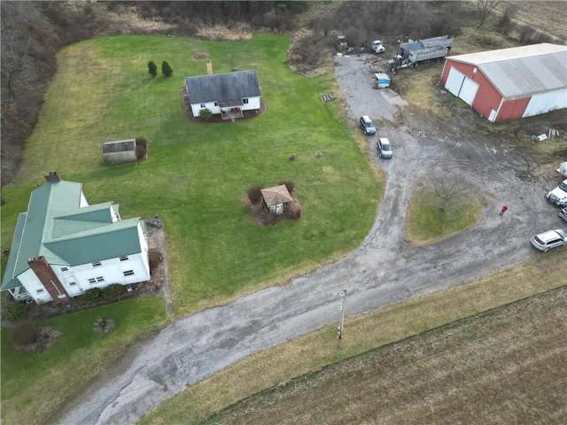 an aerial view of a house with a yard basket ball court and outdoor seating