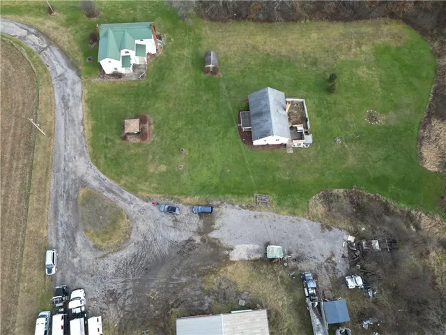 a aerial view of a house with a yard and sitting area