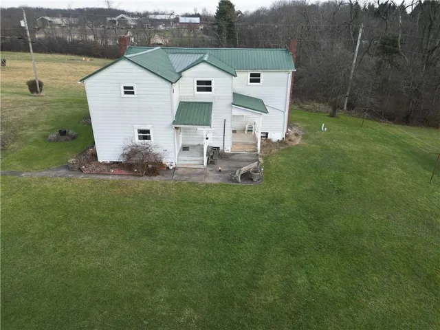 an aerial view of a house with a garden