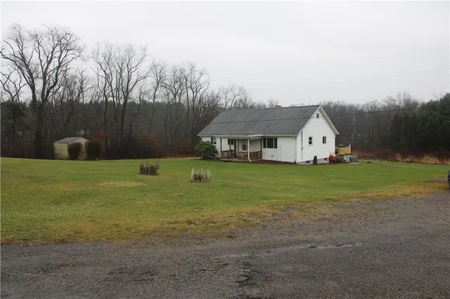 a backyard of a house with outdoor seating