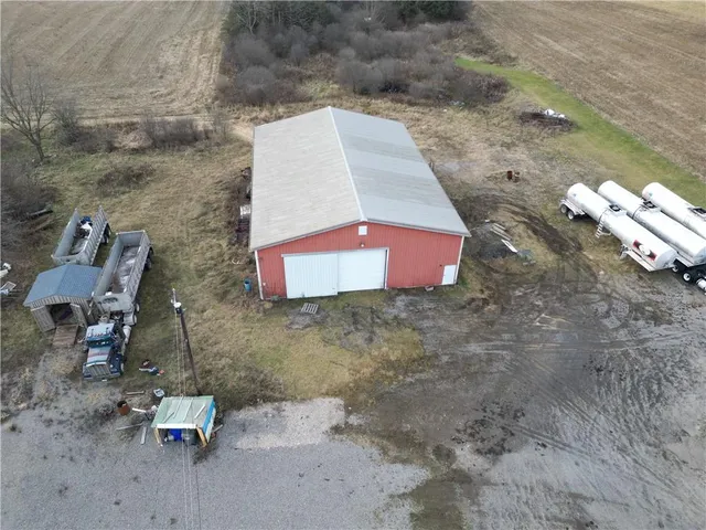 a backyard of a house with yard and trampoline