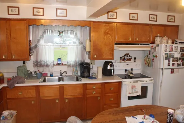 a kitchen with cabinets a sink and appliances