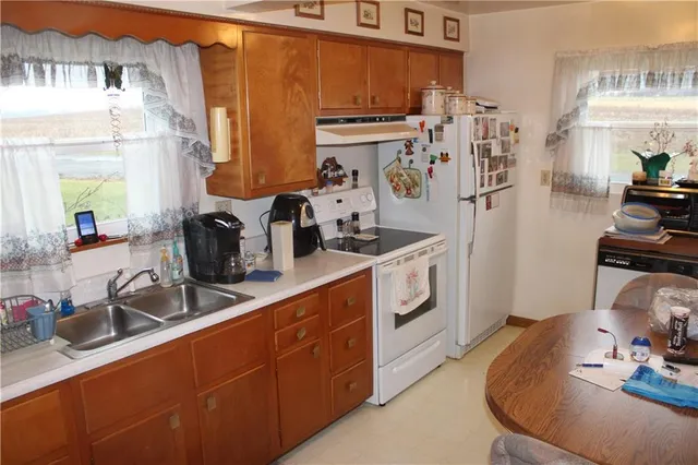 a kitchen with a sink stove and refrigerator
