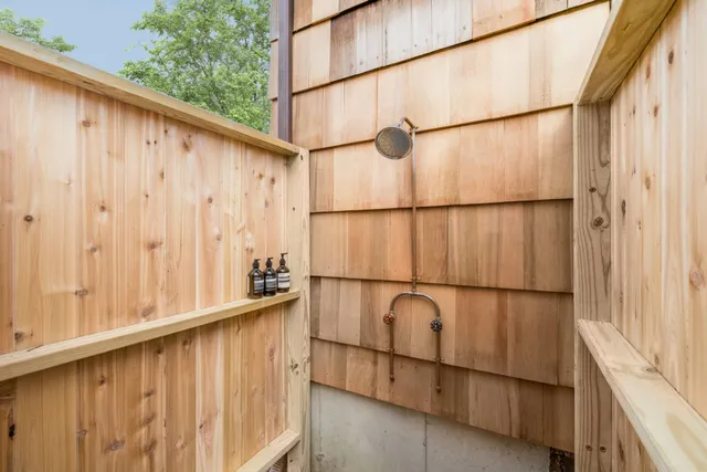 a view of a back yard of a house with a street