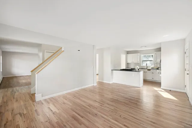 a view of kitchen and hall with wooden floor