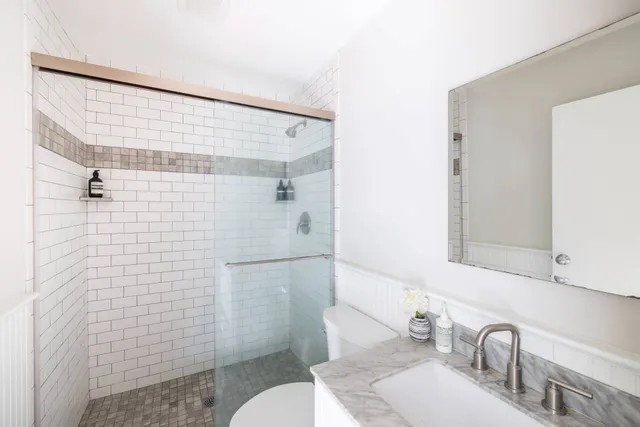 a bathroom with a sink toilet and shower