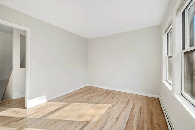 a view of a room with wooden floor and entrance