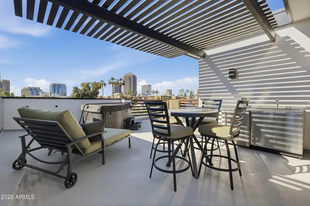 a view of a patio with table and chairs and potted plants