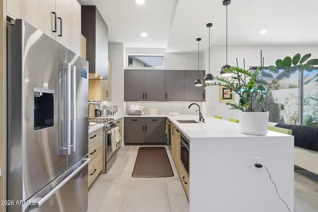 a kitchen with white cabinets and refrigerator