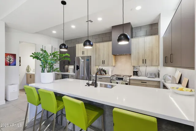 a kitchen with a table chairs sink and microwave