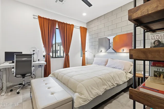 a bedroom with a bed a table and chair