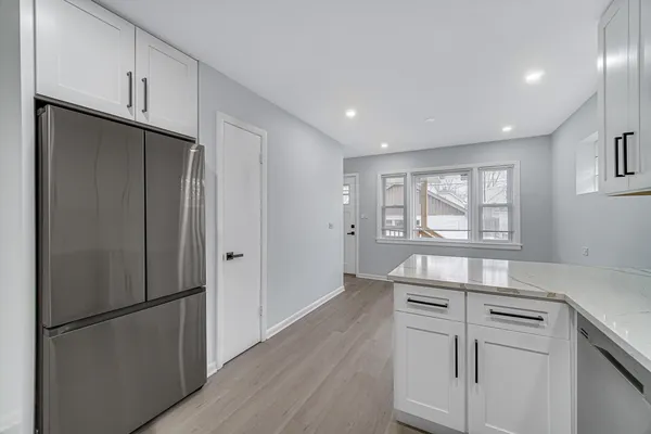 a kitchen with stainless steel appliances granite countertop a refrigerator sink and cabinets