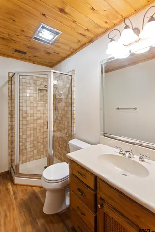 a bathroom with a sink a toilet and shower