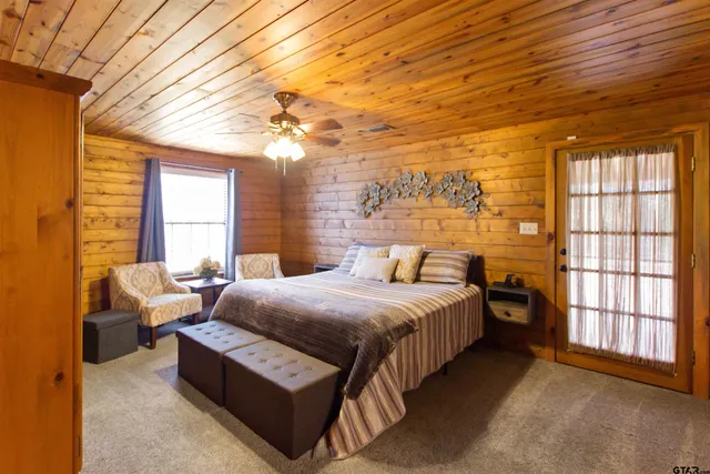 a bedroom with a bed couch and window