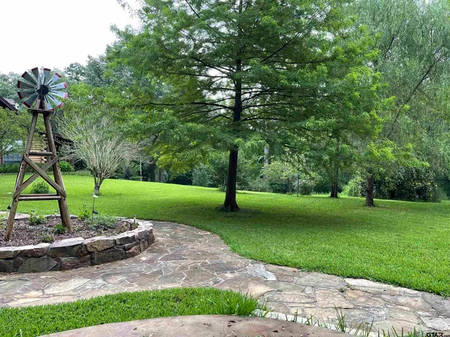 a front view of a house with a tree