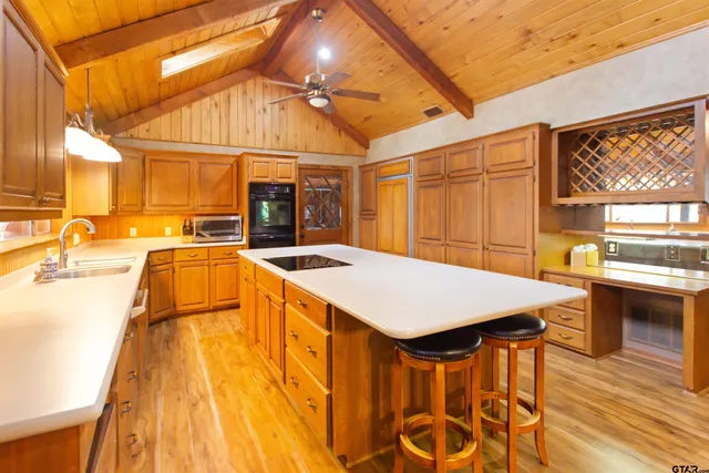 a large kitchen with a table and chairs
