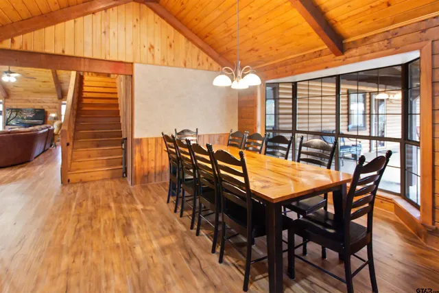 a dining room with furniture and wooden floor