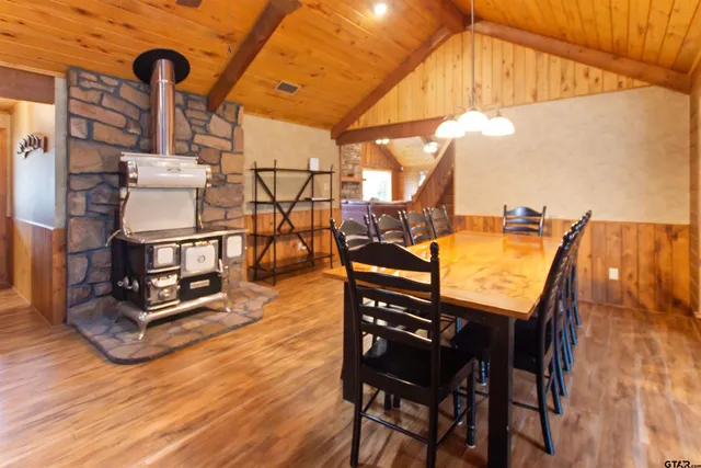 a dining room with furniture and wooden floor