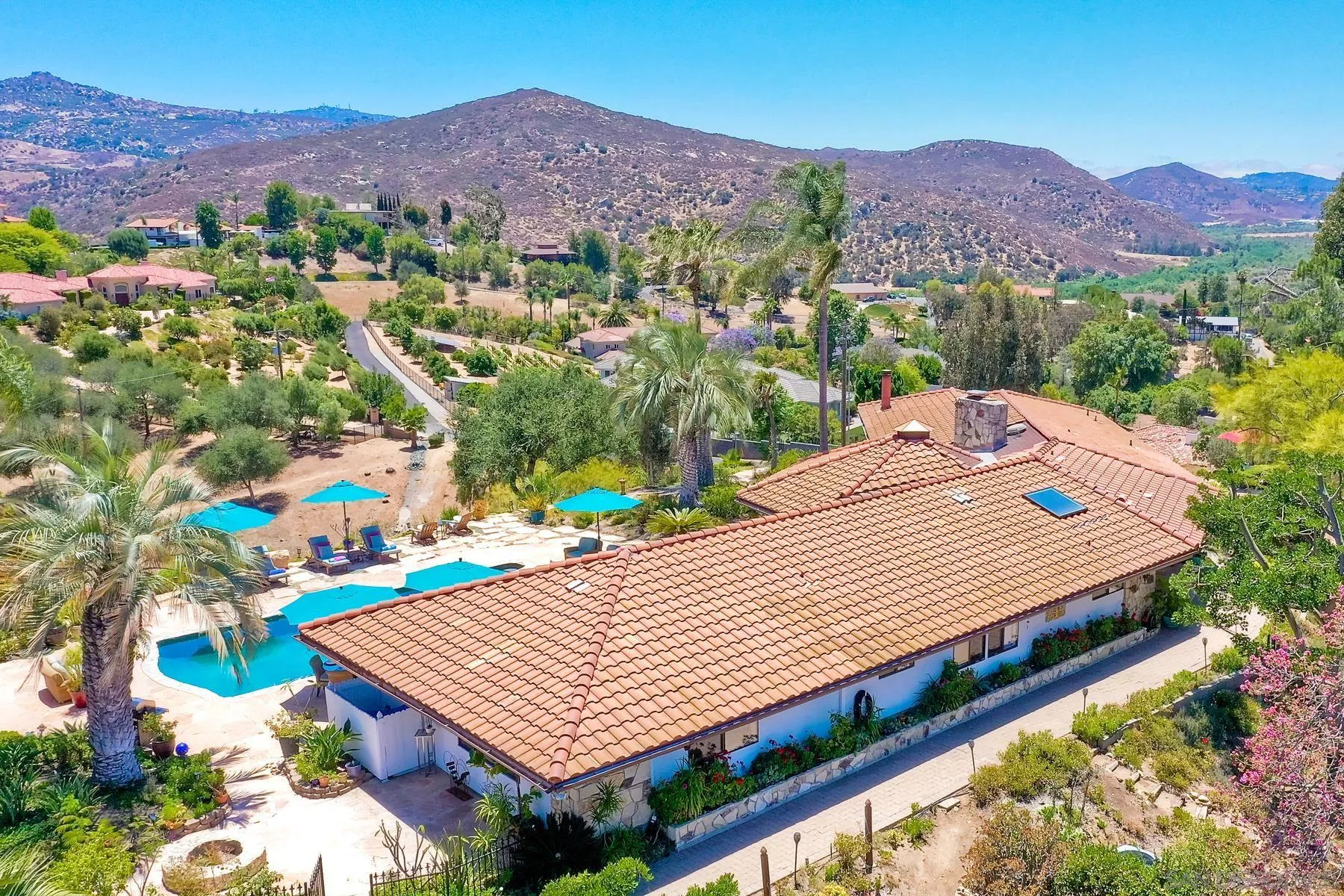 14102 Summit Crest Escondido, CA 92025 - Photo 43 of 52 a view of a patio with a table under an umbrella
