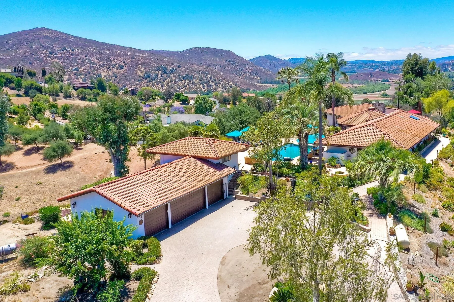 14102 Summit Crest Escondido, CA 92025 - Photo 47 of 52 an aerial view of houses with a street and trees