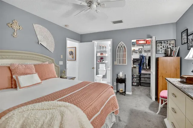 a bedroom with a large bed and a chandelier
