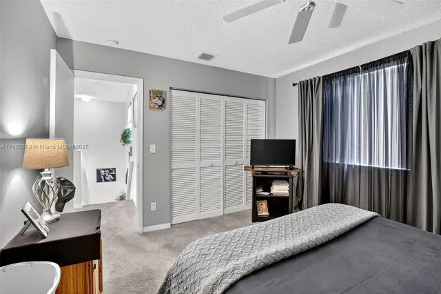 a bedroom with a bed and a television