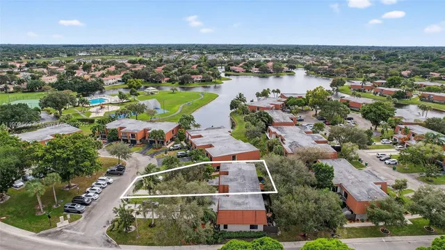 an aerial view of a houses with a lake