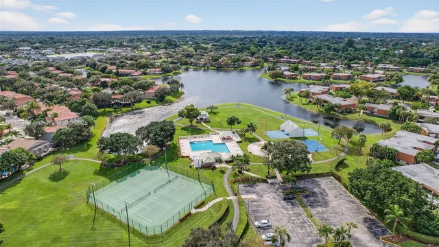 an aerial view of a city with lots of residential buildings ocean and mountain view in back