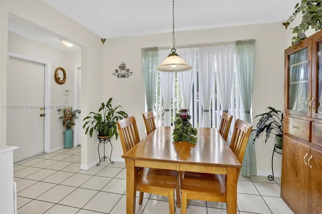 a dining room with furniture and window