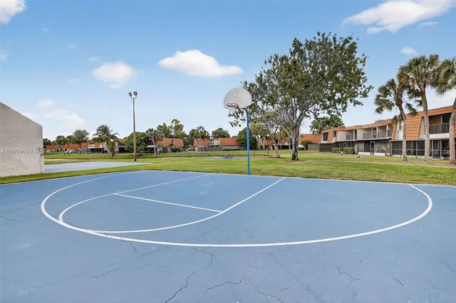 a view of a house with a big yard and large trees