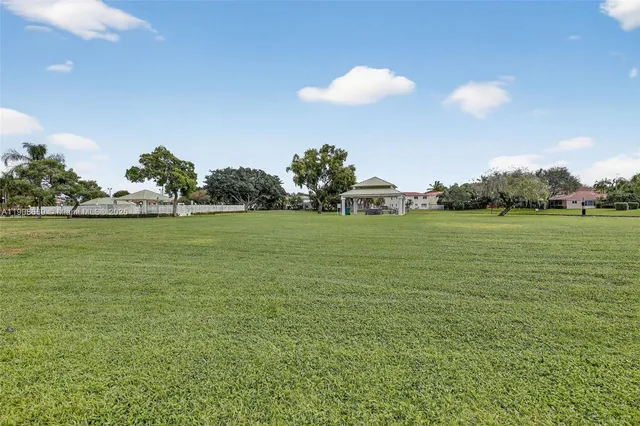 an aerial view of residential houses with outdoor space and lake view