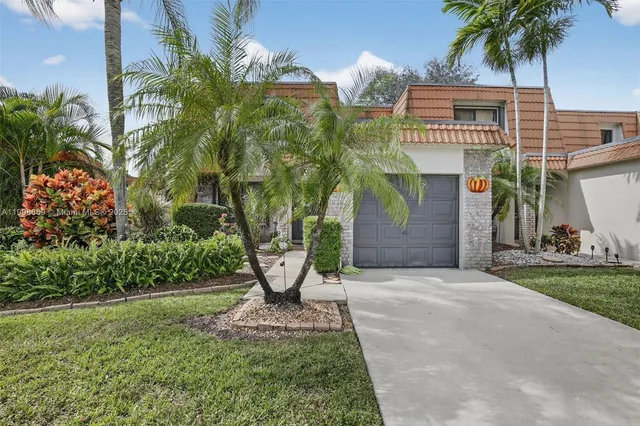 a front view of house with yard and green space
