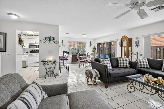 a living room with furniture and view of kitchen