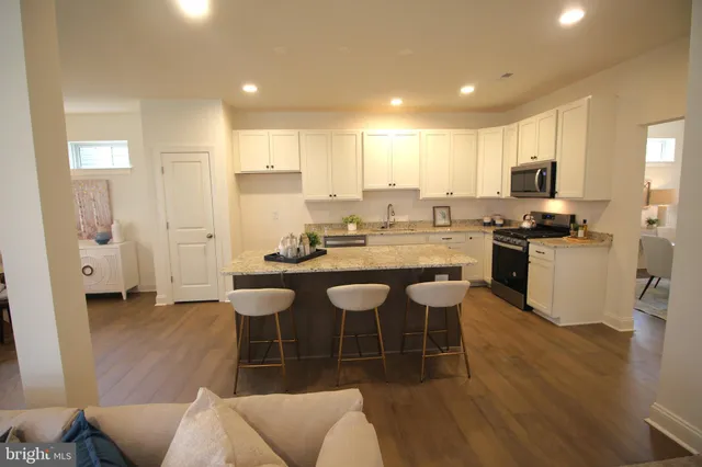 a large kitchen with a table and chairs