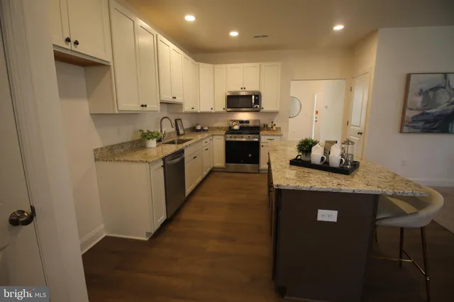 a kitchen with a sink a stove and cabinets