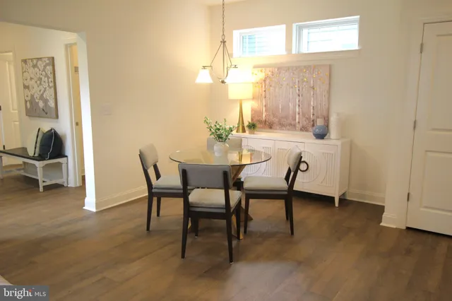 a living room with a couch and a table with wooden floor