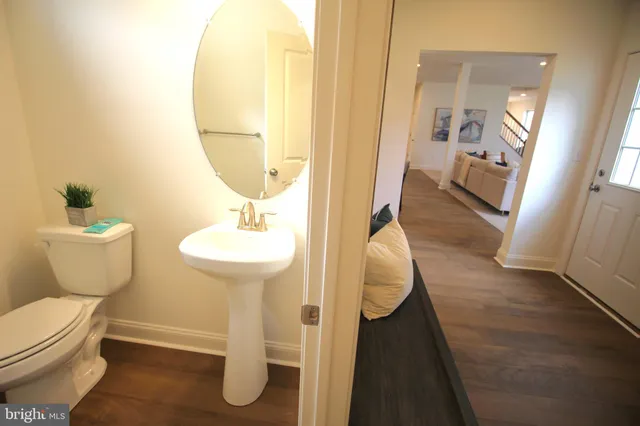 a view of entryway and hall with wooden floor