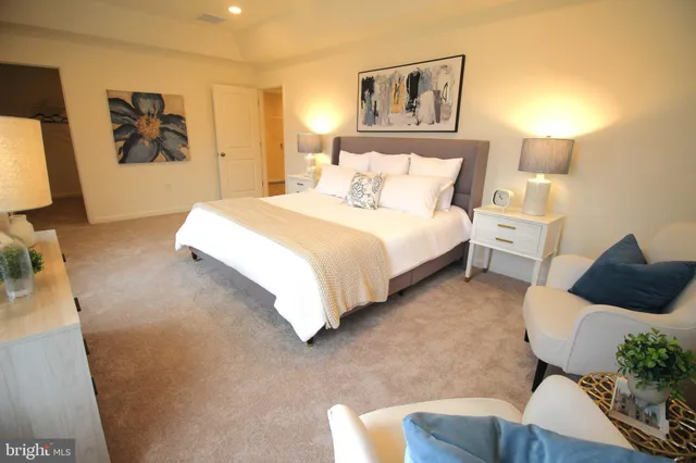 a spacious bathroom with a tub sink and mirror