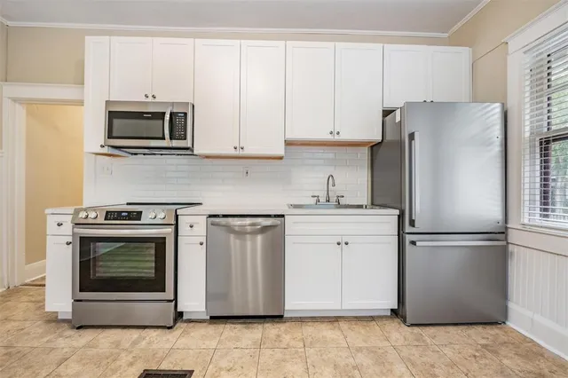 a kitchen with stainless steel appliances granite countertop a refrigerator stove and microwave